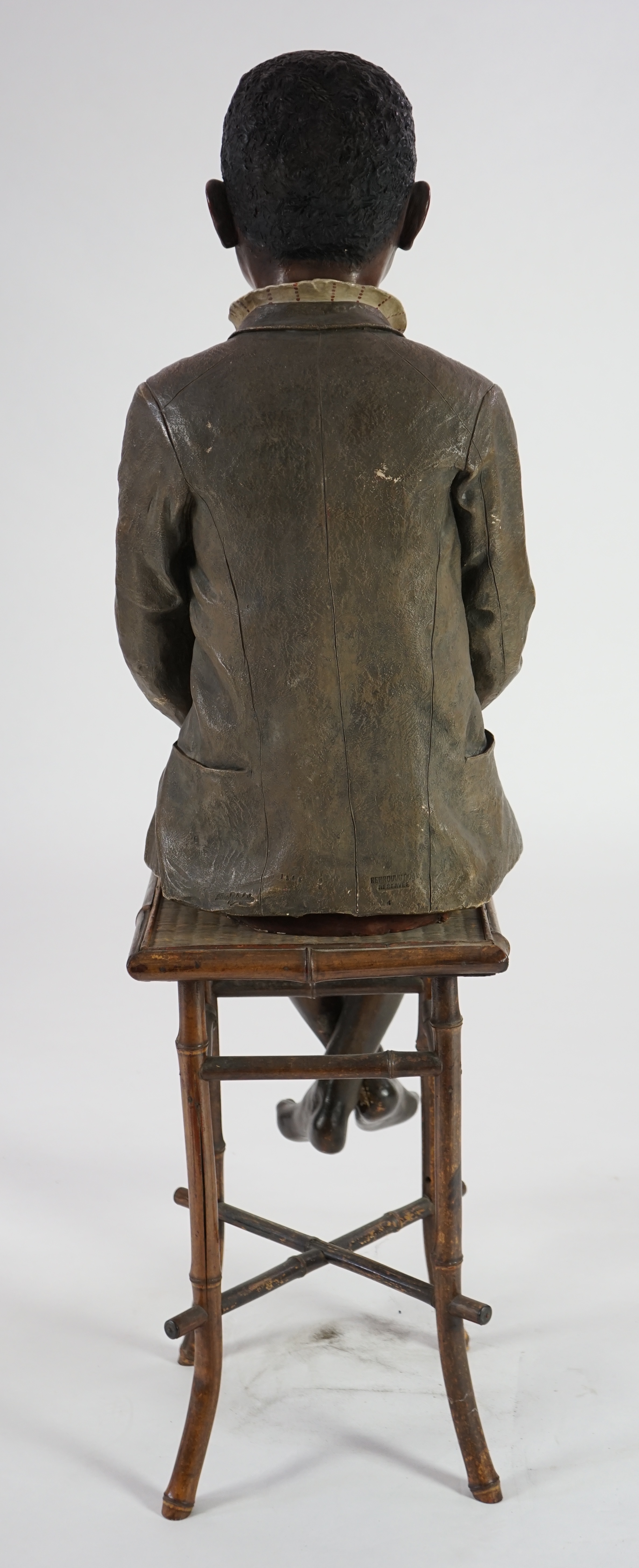 A late 19th century Friedrich Goldscheider life size cold painted terracotta figure of a black boy